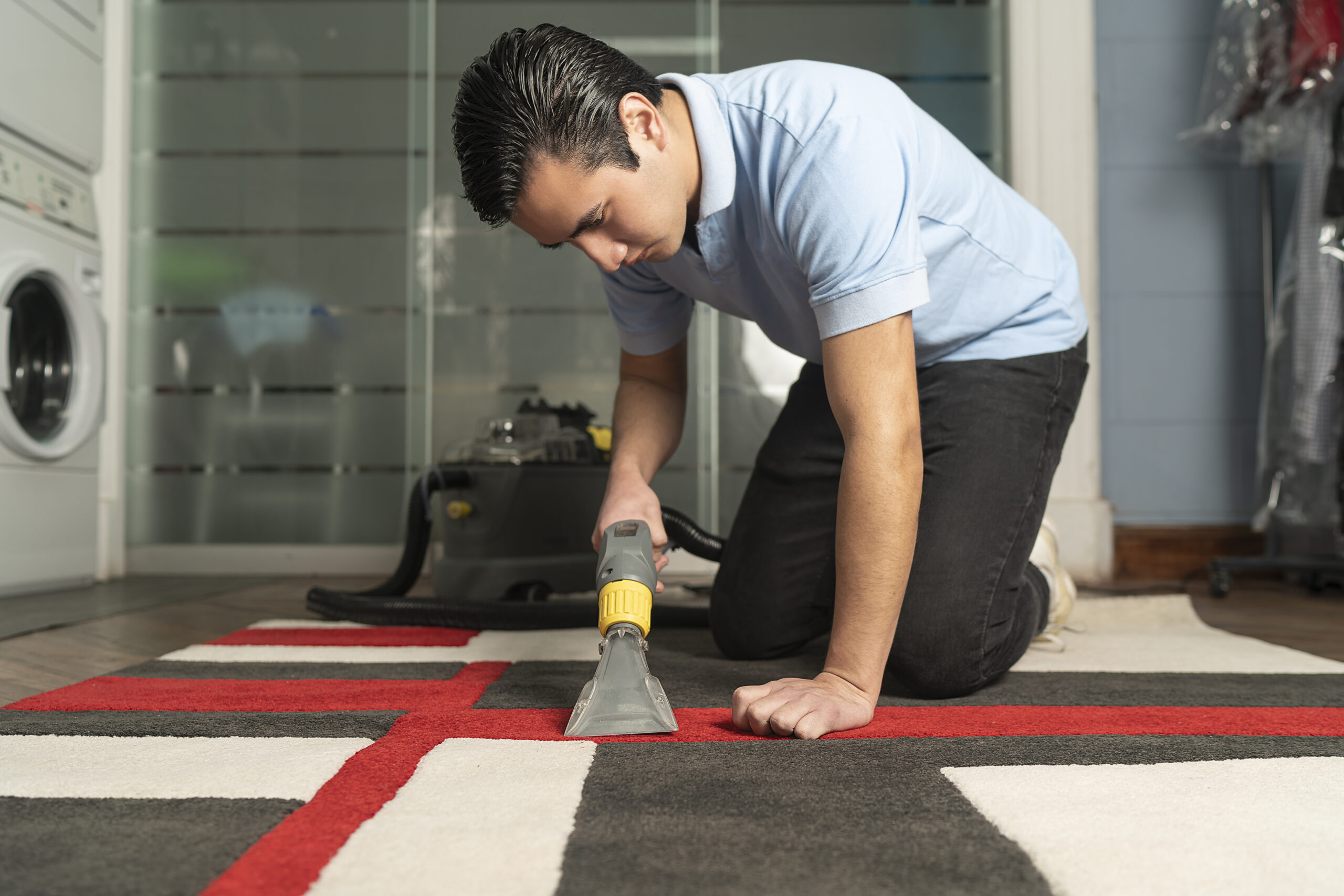 Laundry worker cleaning carpet with special equipment