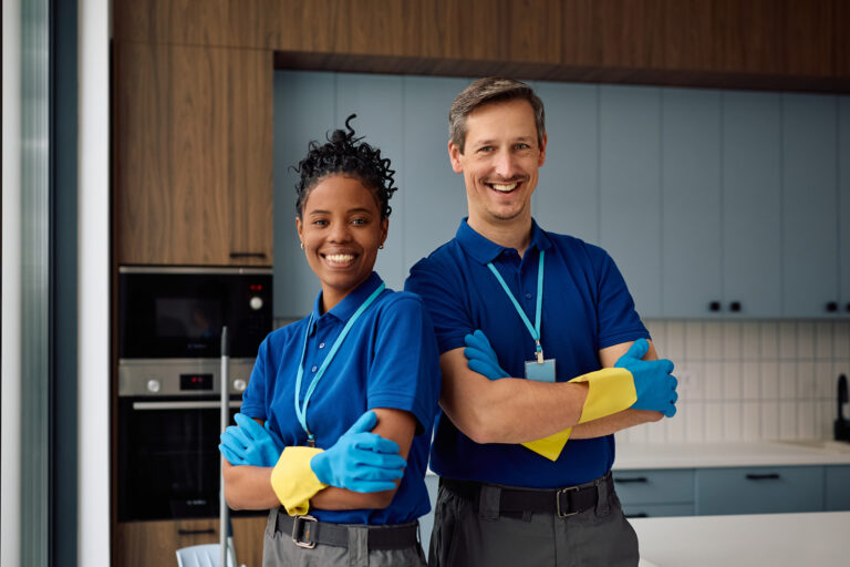 Portrait of confident professional cleaning staff members looking at camera.