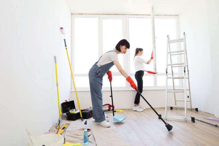 Young beautiful women cleaning up new apartment after renovation.